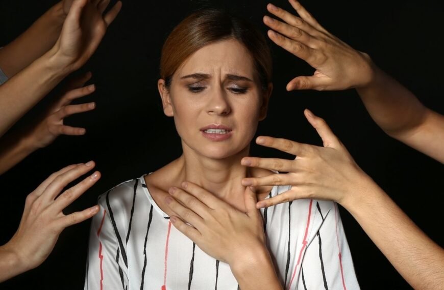 Mulher com expressão de estresse e sobrecarga, cercada por várias mãos apontadas em sua direção, representando o impacto do estresse na menopausa